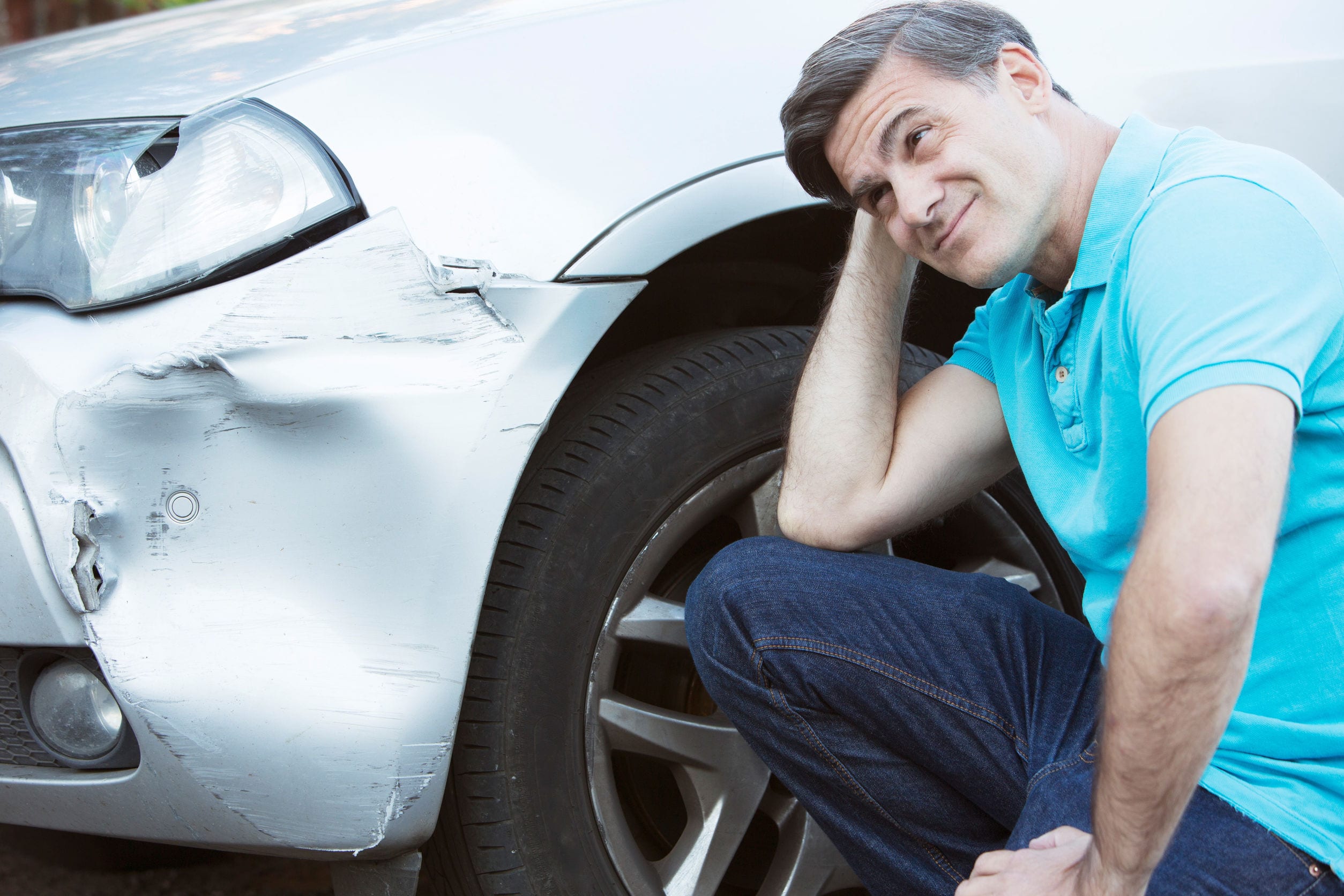 Unhappy Driver Inspecting Damage After Car Accident Unhappy Driver Inspecting Damage After Car Accident