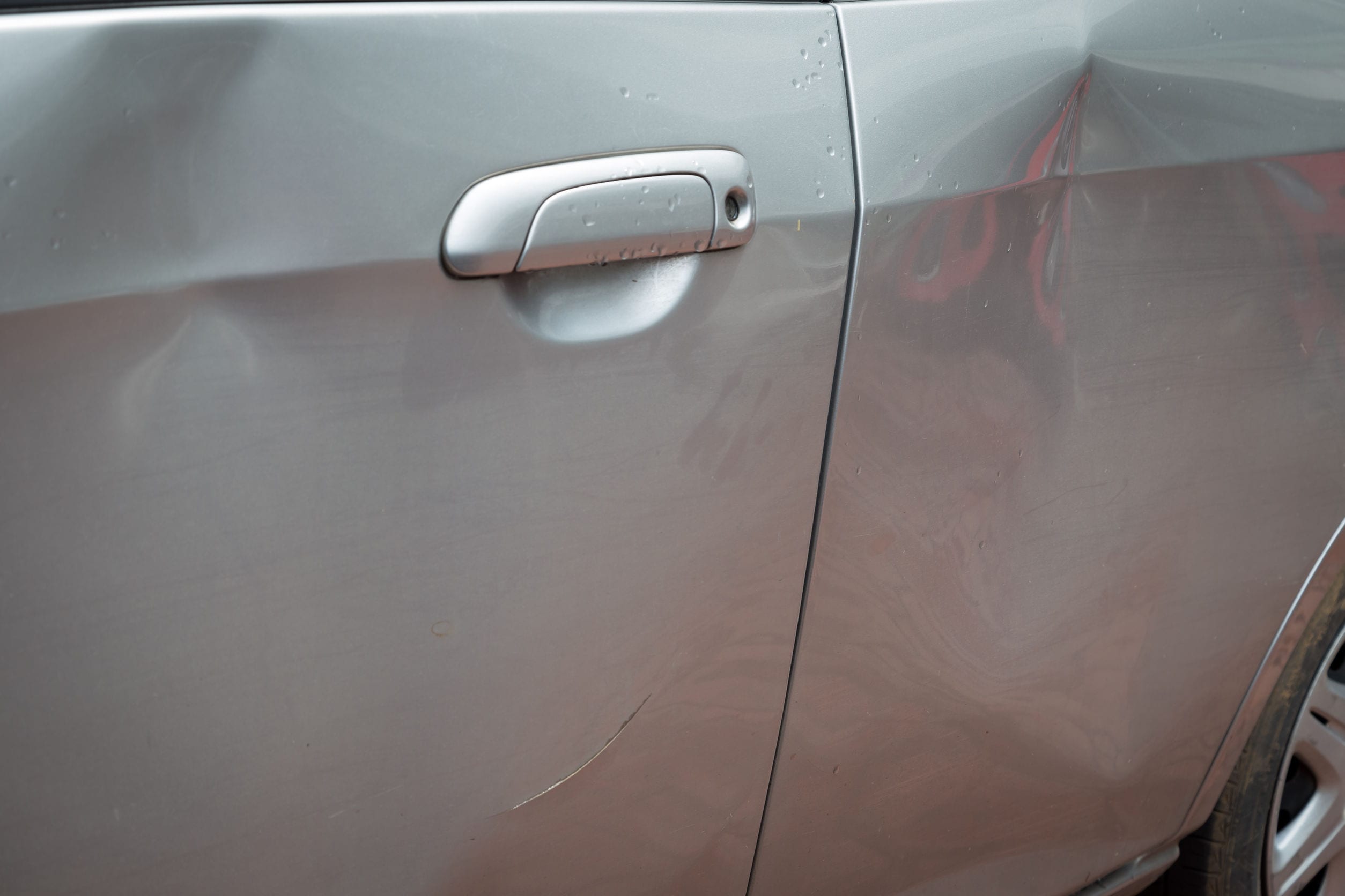 56686528_l 56686528 - door car with damage on accident with dent on left side on raining day
